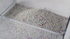 Bentonite cat litter demonstration showing liquid poured onto the granules, clumps lifted with a scoop, and loose litter sifting through.